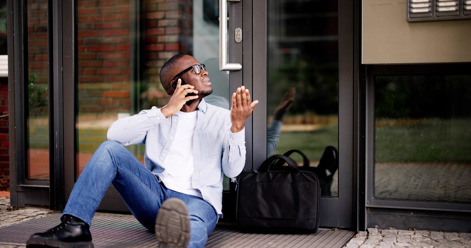 Frustrated African American Man Locked Out of House, Waits for Locksmith
